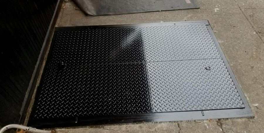 Freshly installed steel diamond plate sidewalk door on NYC sidewalk